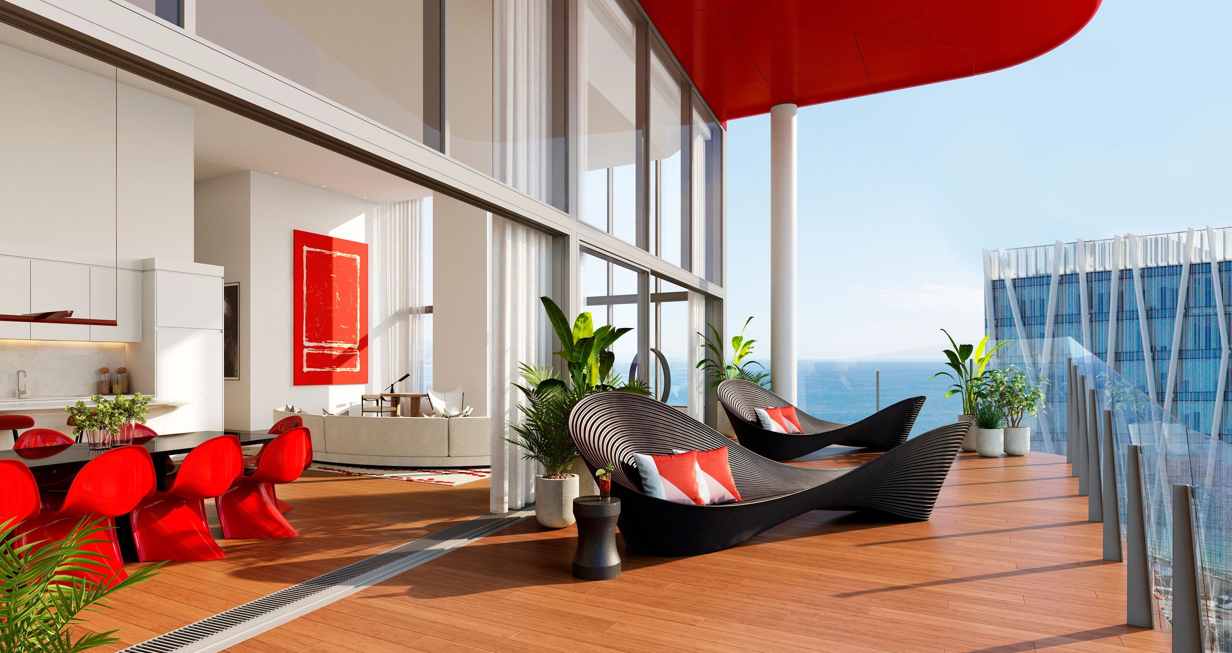View from a private deck with wave-like chaise lounges into a double-height living and dining space with bright red chairs and art, overlooking the Mediterranean Sea; an example of a family-focused luxury investment property in Barcelona.