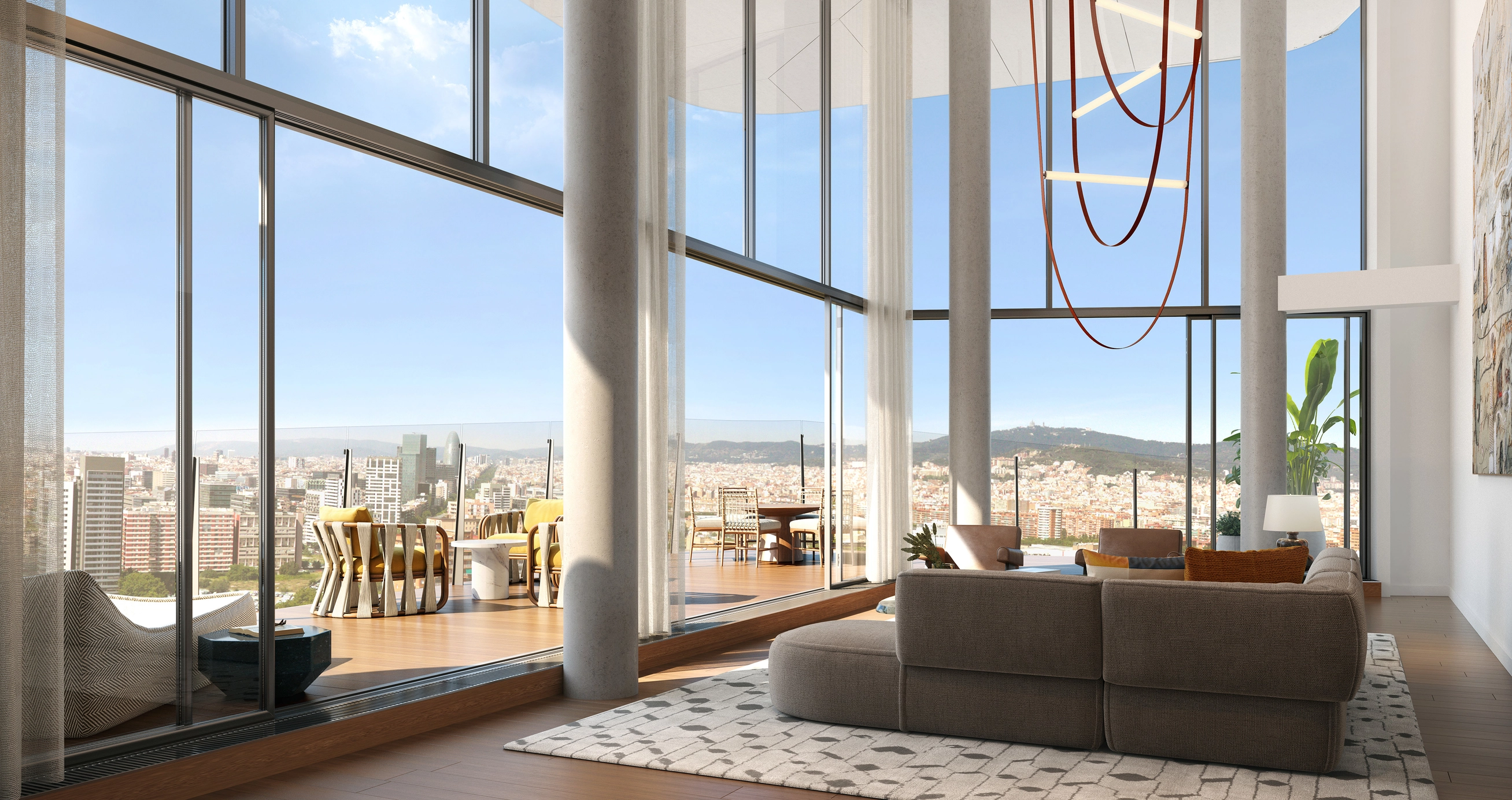 A double-height luxury duplex living room at Antares Barcelona, featuring soaring floor-to-ceiling glass walls and structural columns. The space opens onto a vast wraparound terrace with panoramic views of the Barcelona skyline and Tibidabo mountain, showcasing an elite standard of Mediterranean living and high-end real estate investment.